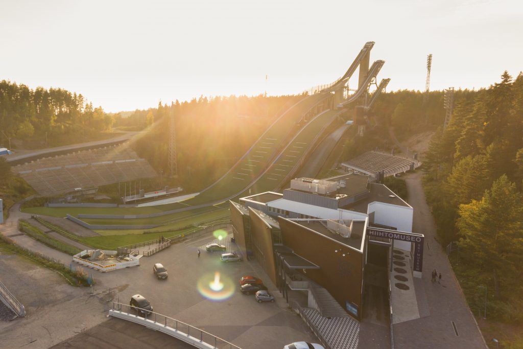 Aerial view of the Ski Museum and the ski jumping towers. The sun is just rising on the horizon